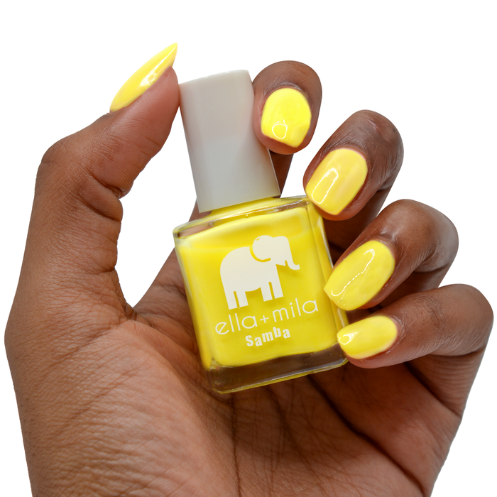 Sunburst vibrant yellow nail polish on a deep skin tone, hand holding the bottle