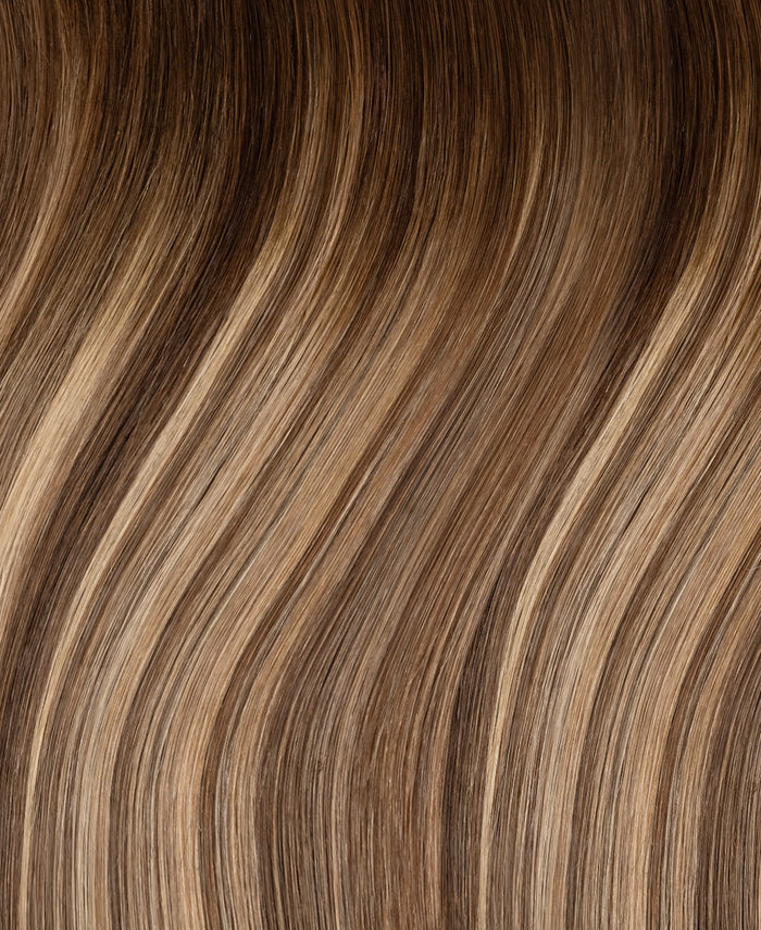 tape-in hair extensions rooted beige highlights.