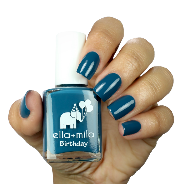 Third Time's a Charm sea blue green nail polish on a medium skin tone, hand holding the bottle