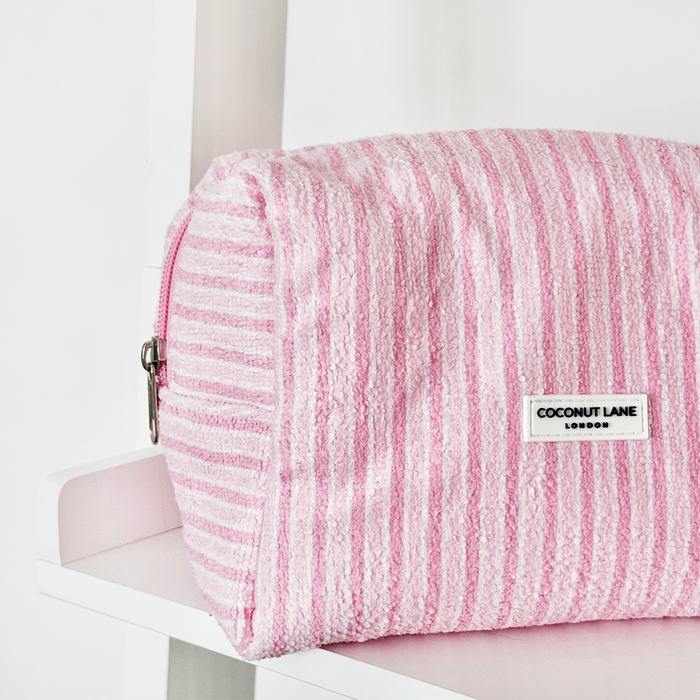Pink and white striped makeup bag with a zipper, featuring a towel-like texture.