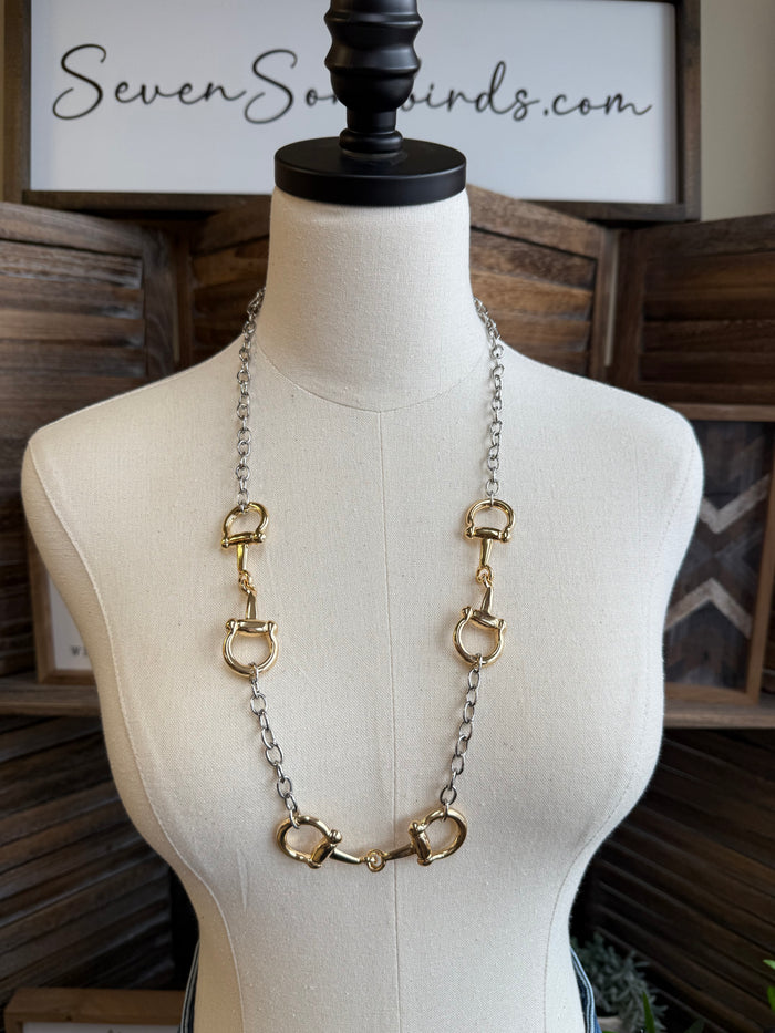 Gold-tone triple snaffle bit necklace with three linked rings and long chain