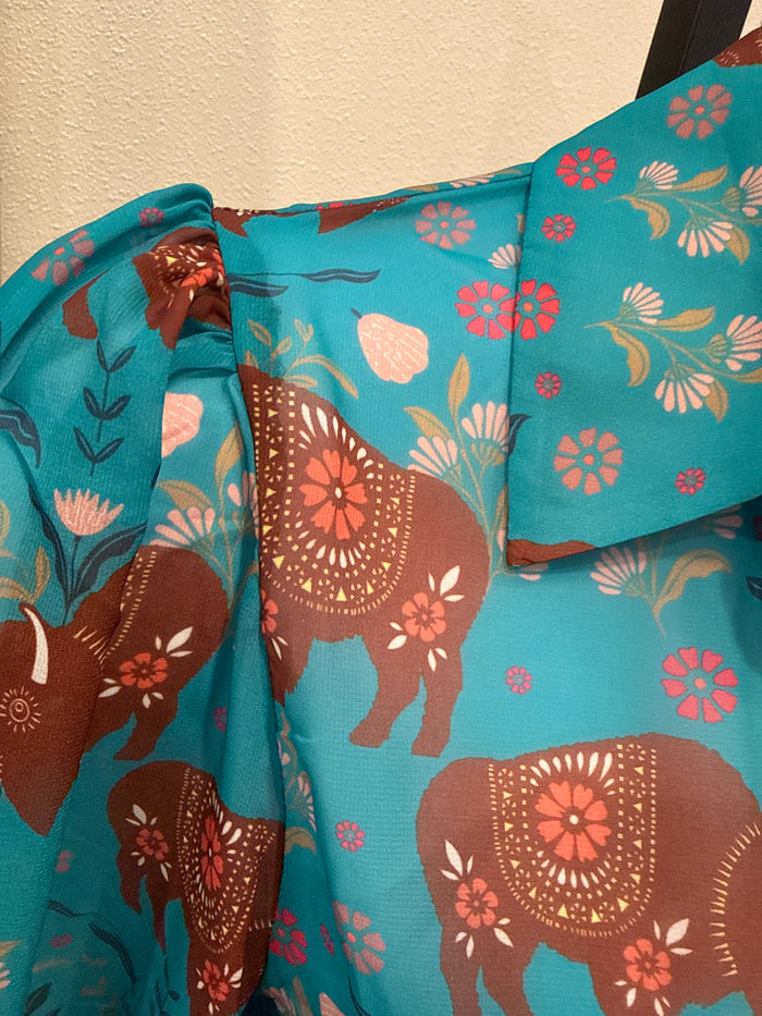 Turquoise semi-sheer blouse detail: puff sleeve, elephant and floral print