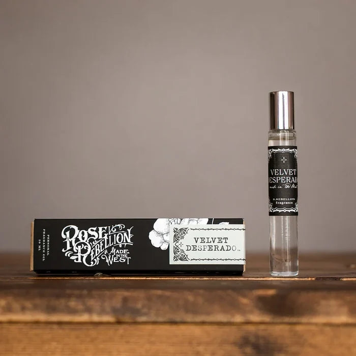 Velvet Desperado roll-on perfume oil bottle and label box on wooden shelf