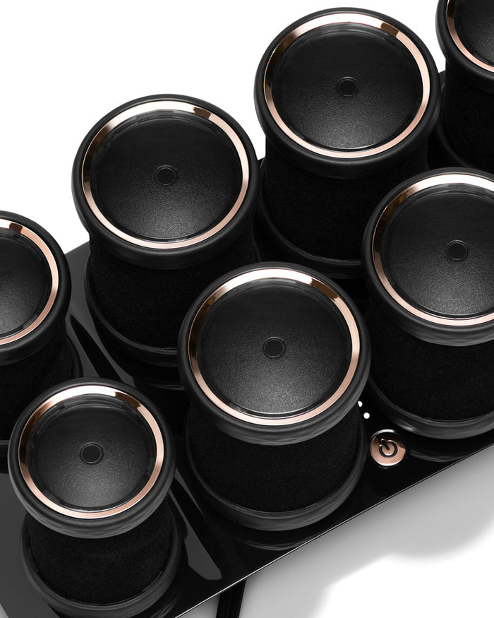 Set of black hot rollers on base with power button
