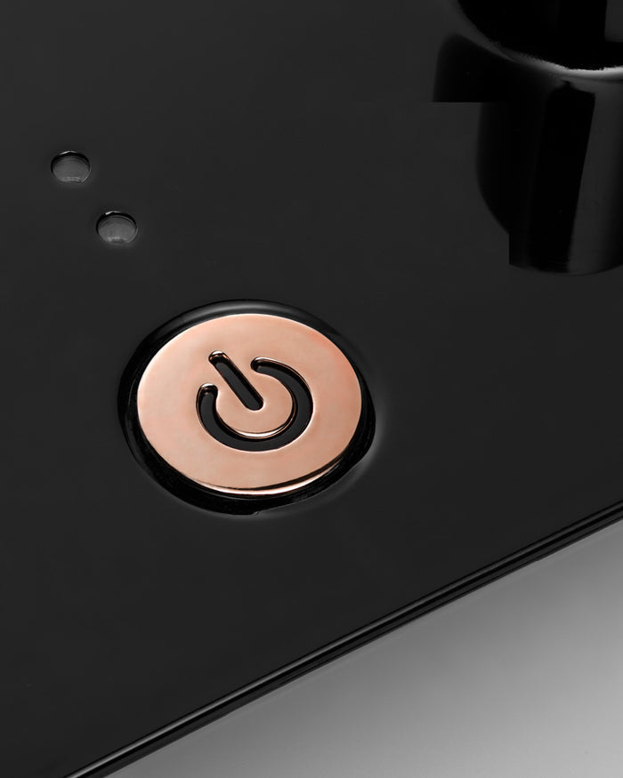 Black electronic device with a copper power button