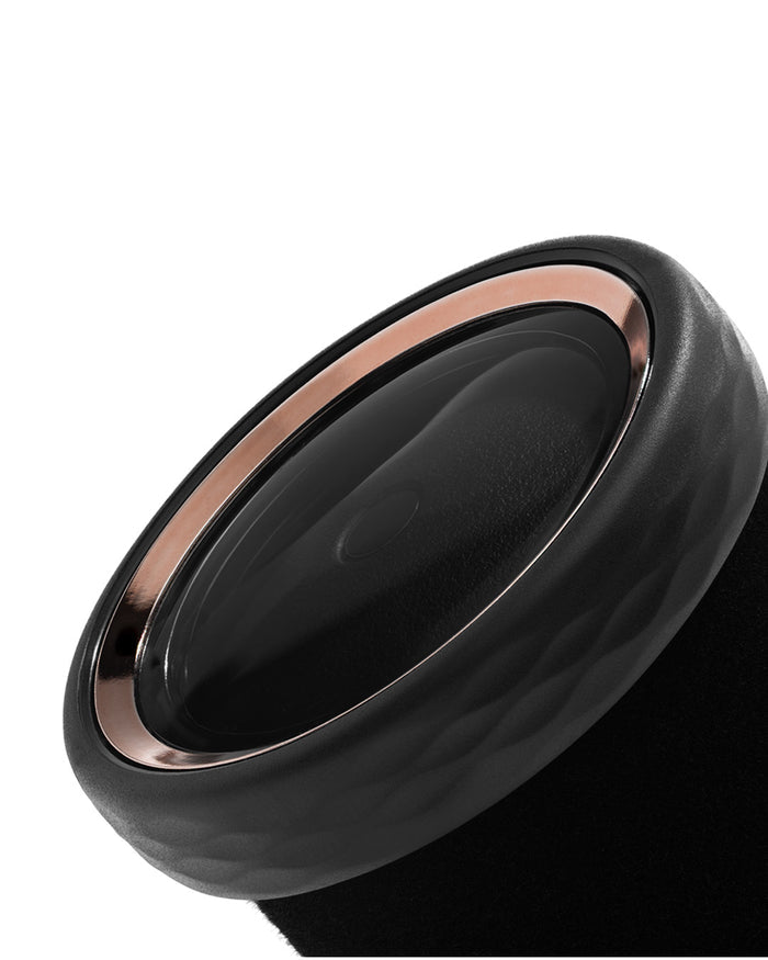 Black and rose gold ring on a white background