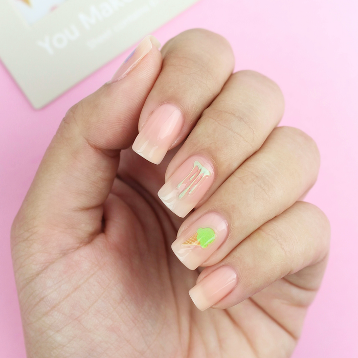 You Make Me Melt green drip decal on a sheer nude manicure with the packaging
