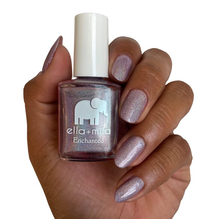 Zephyr silver lilac holographic nail polish on a deep skin tone, hand holding the bottle